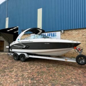 2008 Chaparral 236 full side profile on trailer with guide poles v8 boat engine