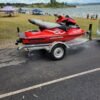 Sea-Doo XP DI rear seating view on trailer Caption: Rear seating view on trailer Description: Rear seating view of the Sea-Doo XP DI on a trailer, showing the slim seat design and compact rear deck optimized for solo performance riding