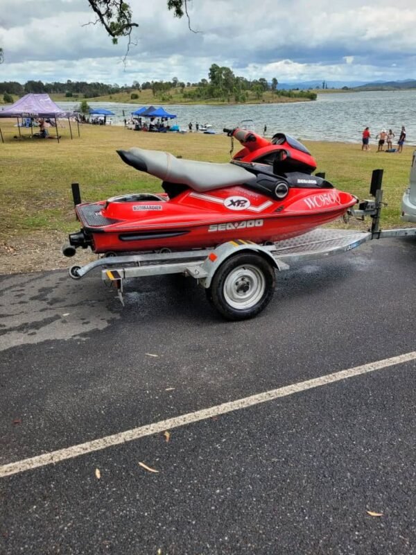 Sea-Doo XP DI rear seating view on trailer Caption: Rear seating view on trailer Description: Rear seating view of the Sea-Doo XP DI on a trailer, showing the slim seat design and compact rear deck optimized for solo performance riding